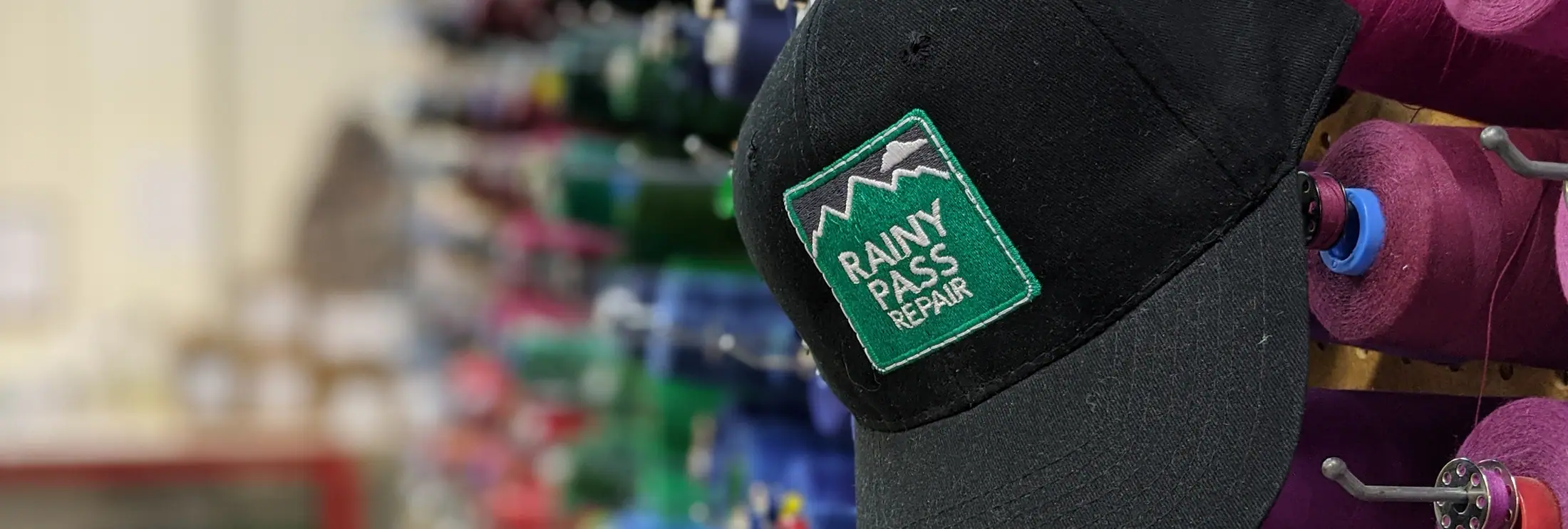 Rainy Pass Repair hat on the shop wall